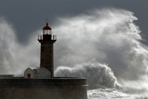 Huge wave over old lighthouse of Porto, Portugal